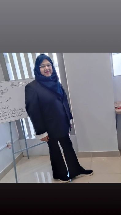 A trainer standing beside a whiteboard covered in notes planning a winter bootcamp schedule