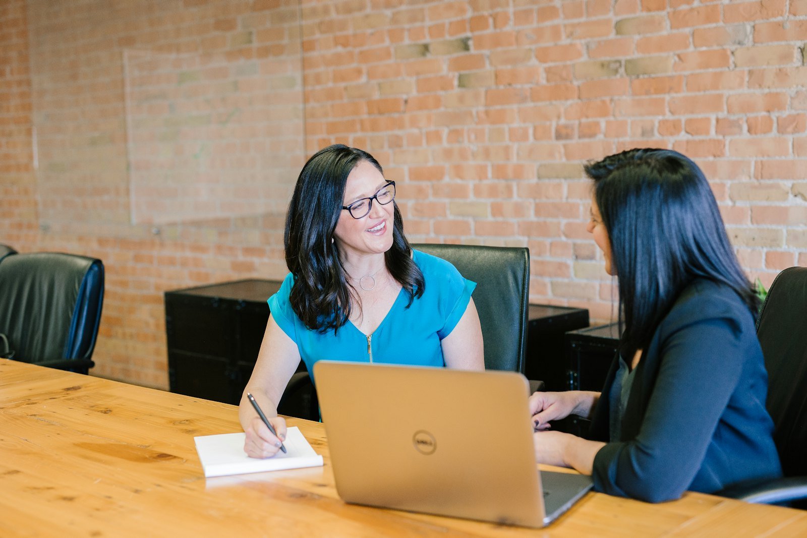 A woman coach in conversation with a woman client during a one-to-one NLP coaching session