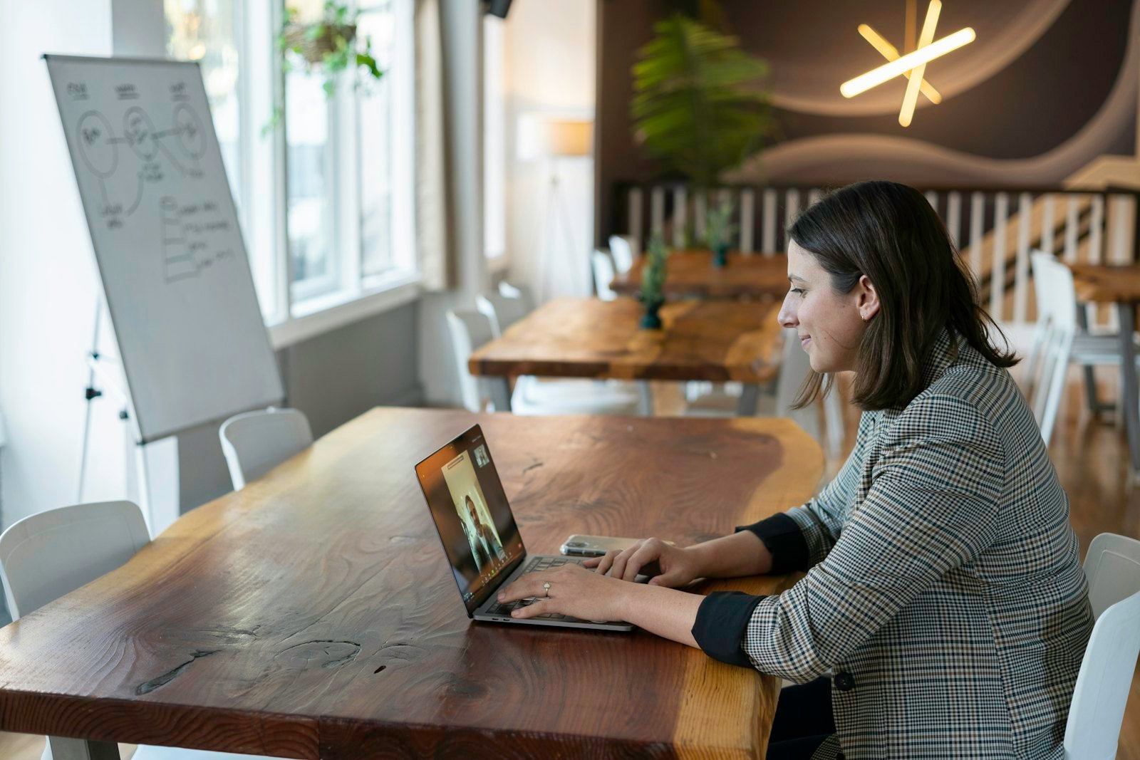 A woman taking an online counselling session on her laptop from home